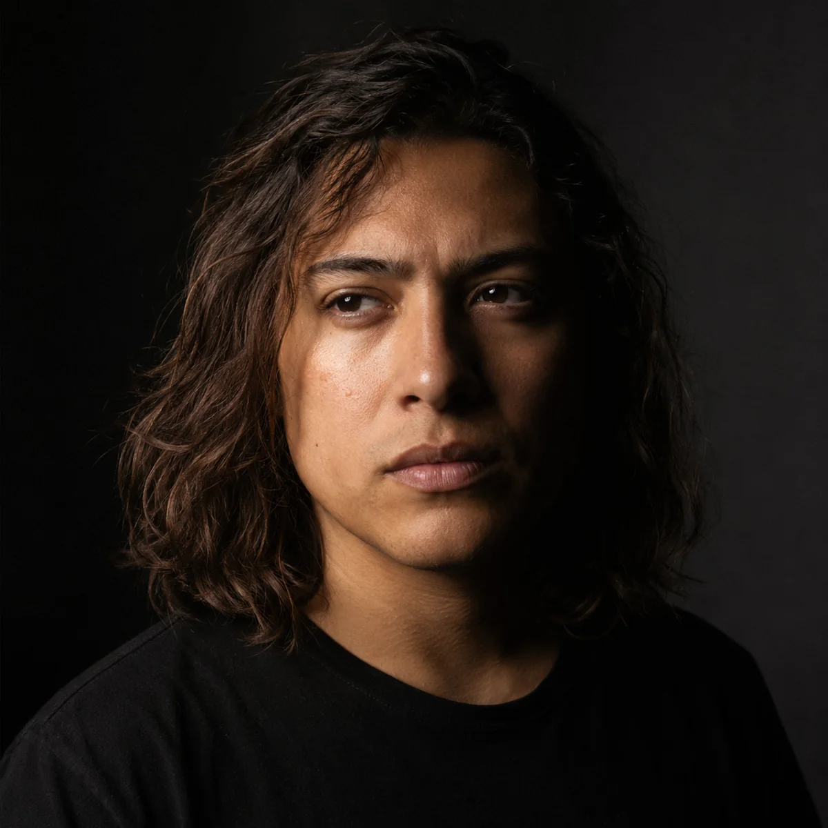 AI headshot gallery — black-and-white theatrical actor headshot of a long-haired person in a black tee, professional headshot AI
