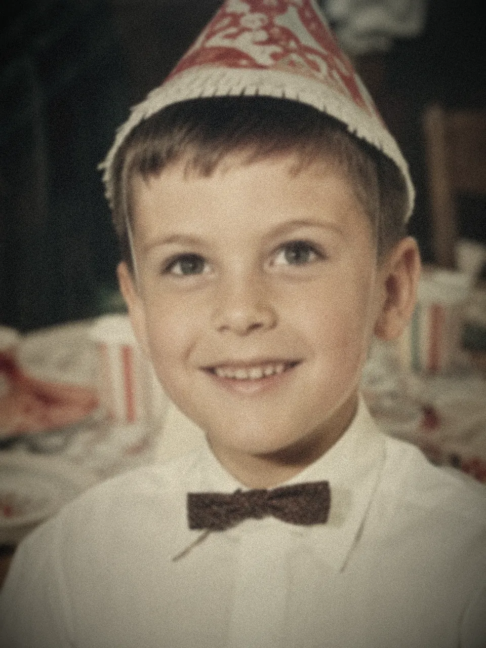Before restoration — a blurry, grainy 1960s child portrait that is soft and out of focus