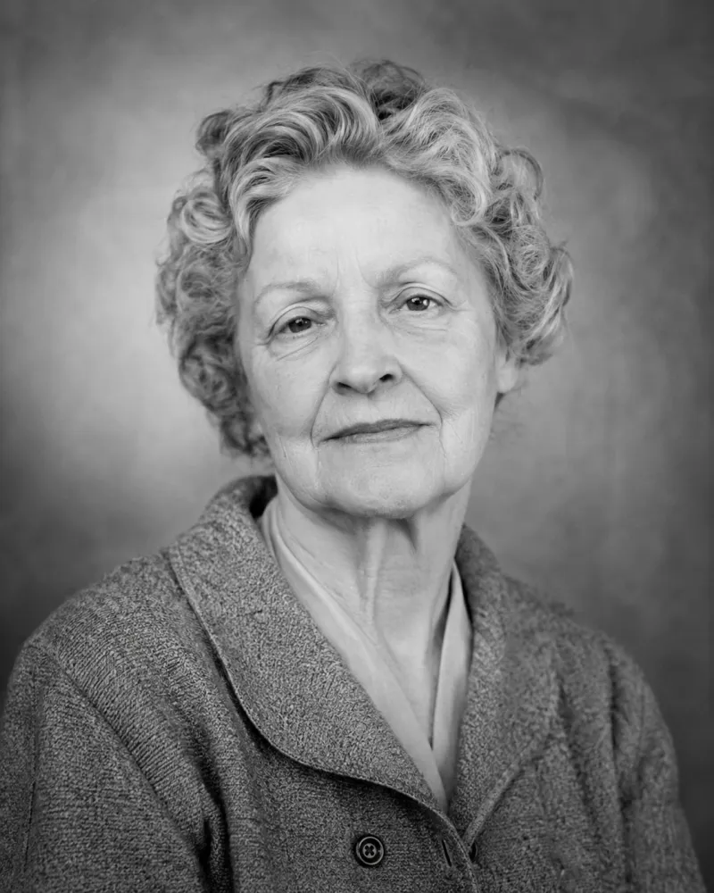 AI Old Photo Revival scene — a serene 1960s woman in a restored black-and-white portrait, breathing softly