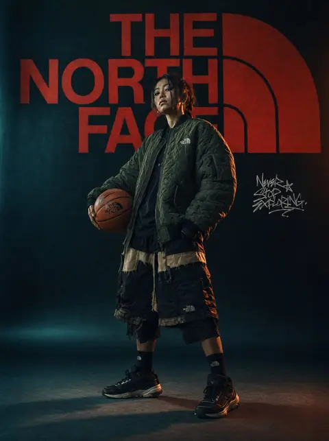 Urban streetwear portrait in a technical outdoor jacket against city architecture